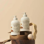 SKINFOOD Honey Rich Body Wash 450ml and Body Essence on a wooden display for skin nourishment.