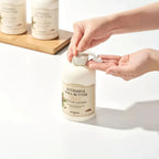 Person dispensing SKINFOOD Intensive Shea Butter Cream Lotion 450ml with an easy-pump bottle.